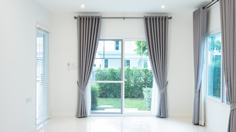 Gray drapes hanging from ceiling