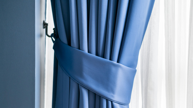 Blue curtain tie-back on hook