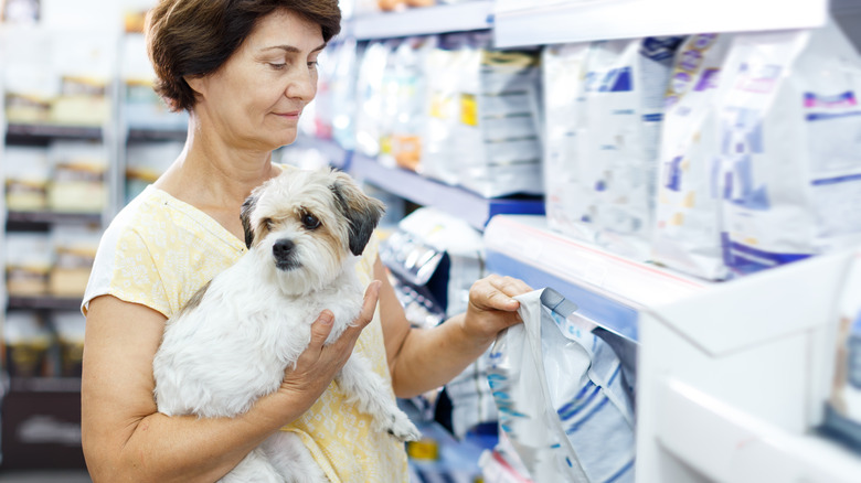 Woman holding dog food bag