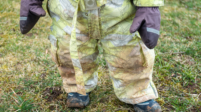 little kid with muddy clothes