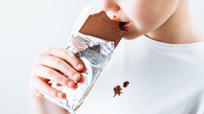 kid with chocolate on shirt