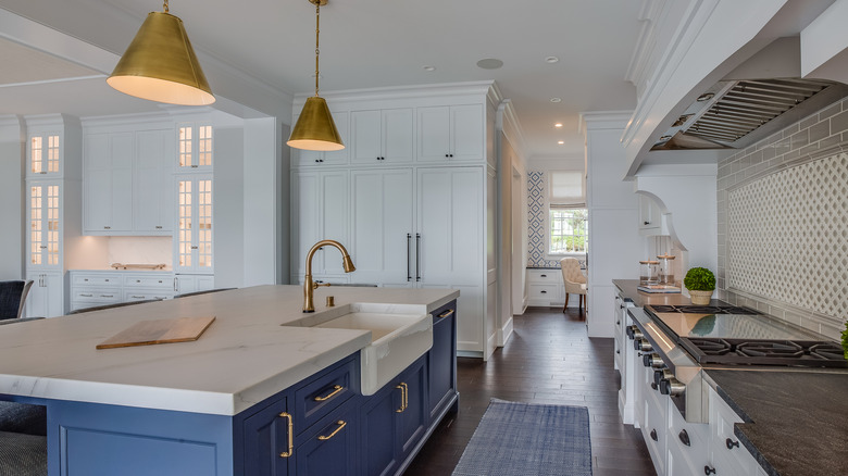 Farmhouse sink in a deep blue kitchen island