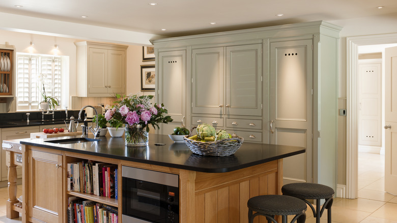 Kitchen island with an exposed bookshelf for cookbooks