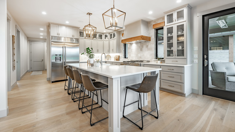 Island in modern kitchen with five stools