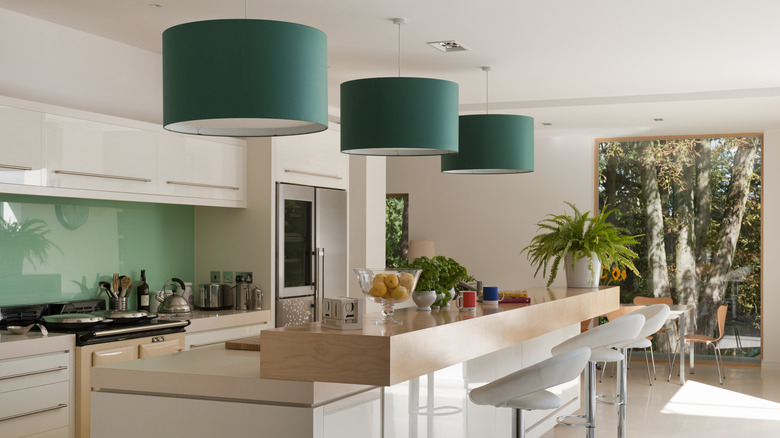 Green statement lights hanging above a kitchen island.