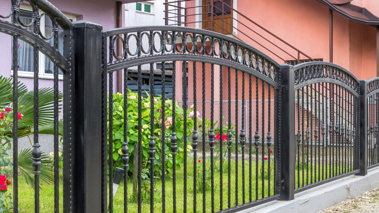 arched top wrought iron fence with circular design