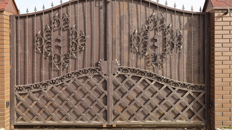 a closed metal wrought iron gate