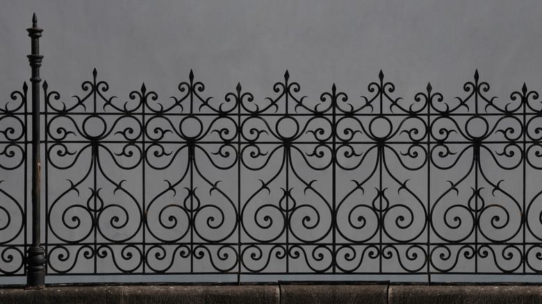 ornamental wrought iron fence with scrolls, hearts, and spears