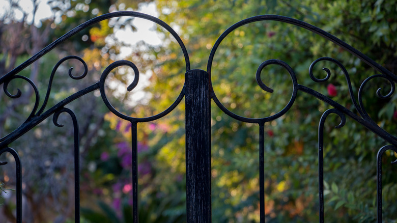 wrought iron fence with two scrolls meeting at picket