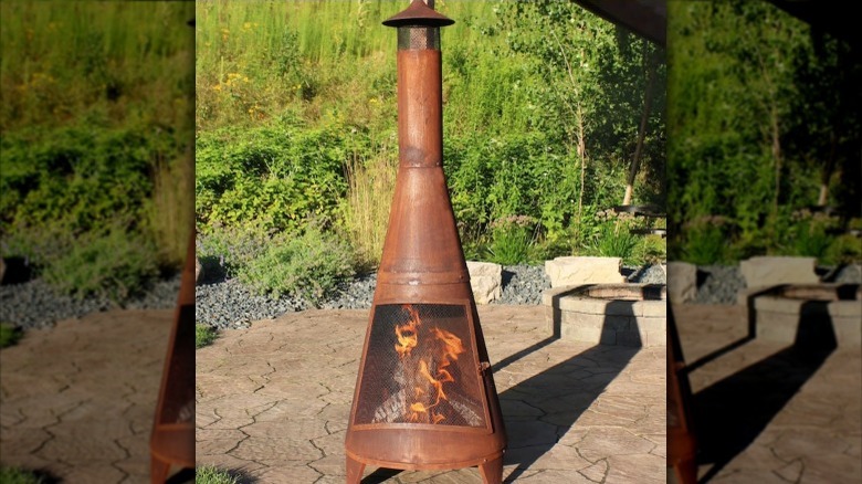 Rustic orange chiminea with mesh