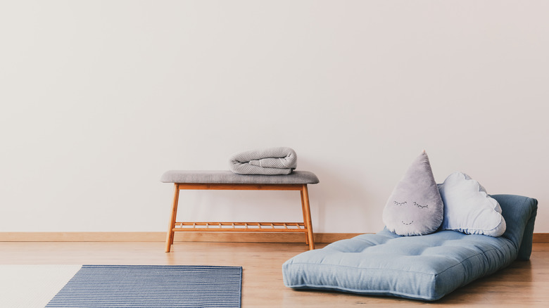 Blue futon cushion on floor