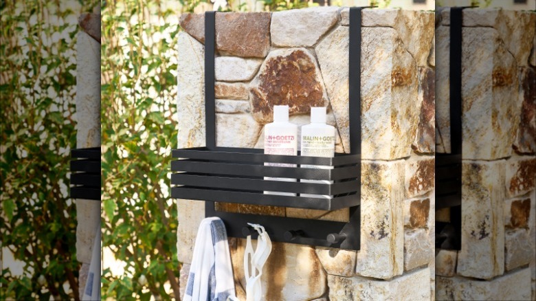 Black shower shelf with bottles