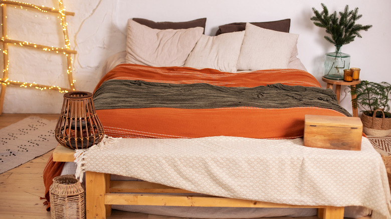 Scandinavian bedroom orange blanket