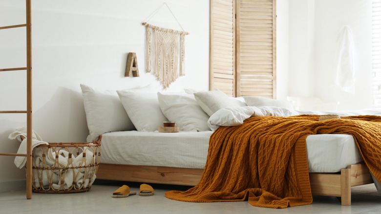 Orange throw blanket white bedroom