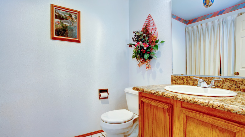 faux floral decoration above toilet