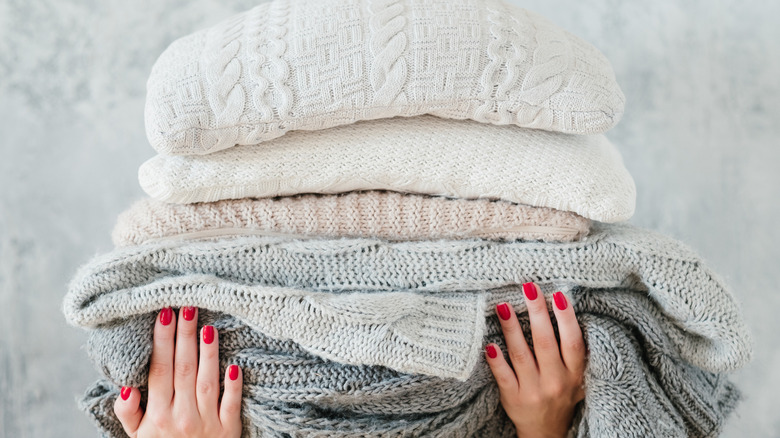 Person carrying wool blankets