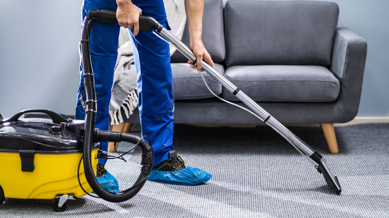 man cleaning rug