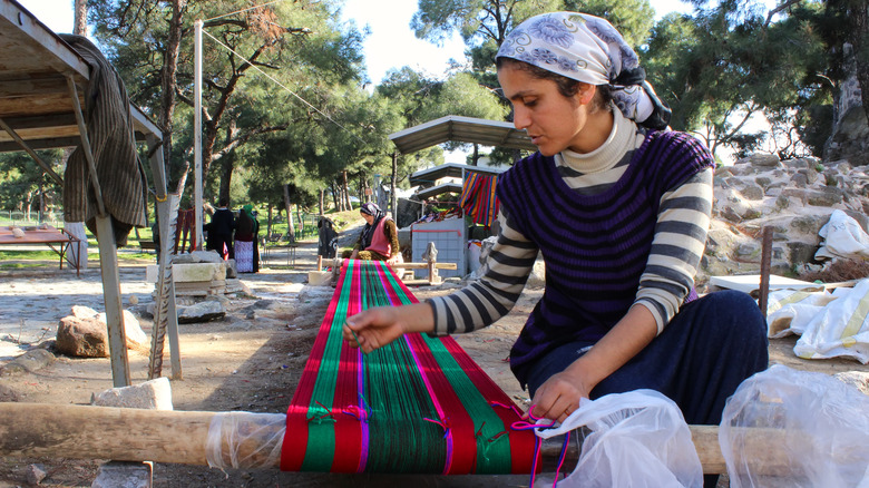 woman weaving rug