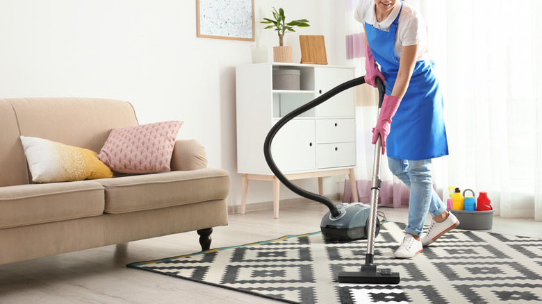 woman cleaning rug