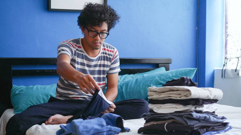 A man folding his laundry