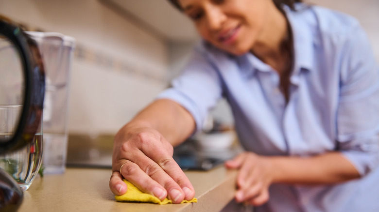 A woman cleaning the counter