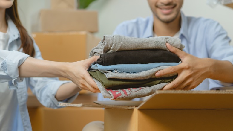 smiling couple unpacking clothes