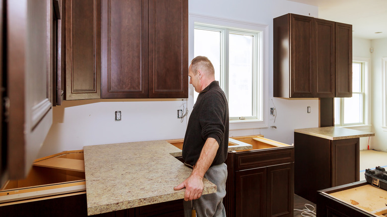 Kitchen with laminate countertop being installed