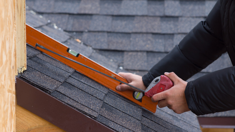 Man installing membrane tiles