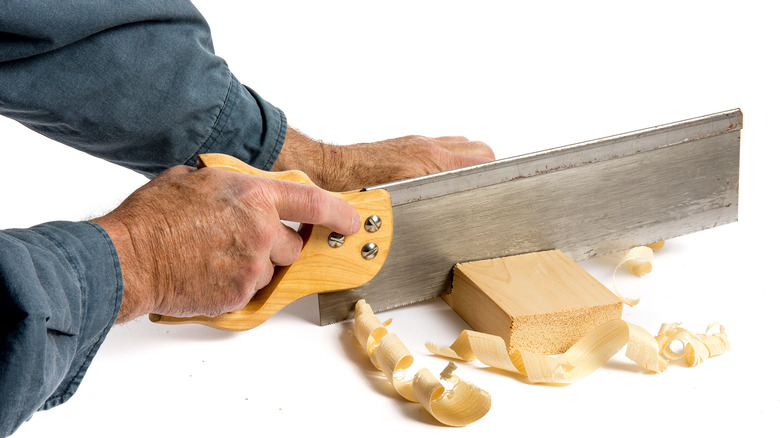 man using backsaw