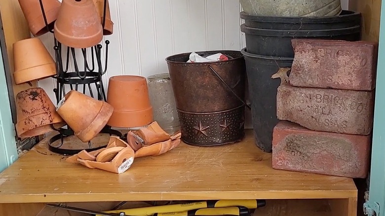 Gardening supplies inside a repurposed armoire