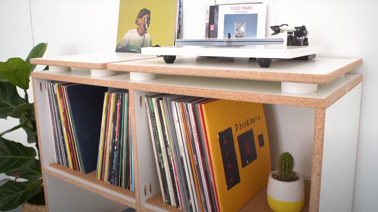 A cabinet with a record player and vinyl