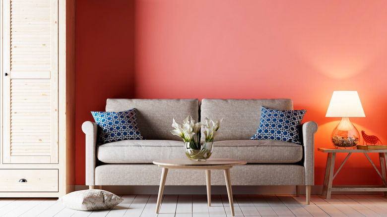 Coral wall with gray couch