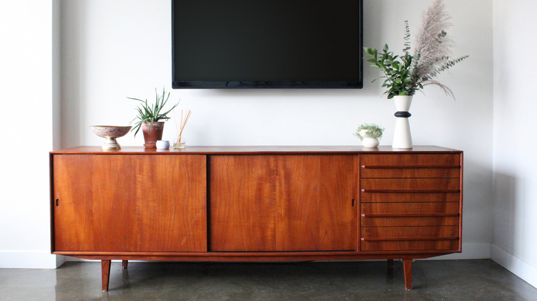 Mid-century modern credenza below TV