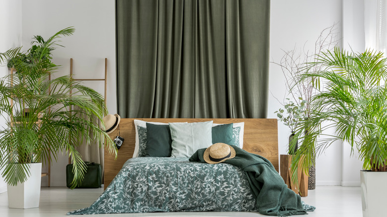 green curtains behind bed