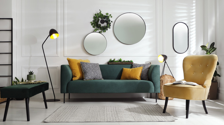 two round mirrors above couch