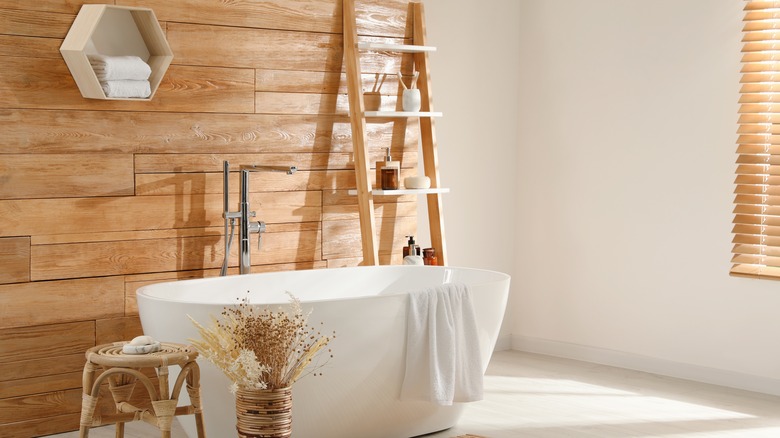 warm wood panels behind bathtub