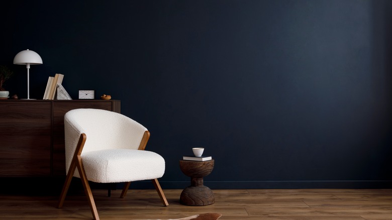 navy wall with white chair