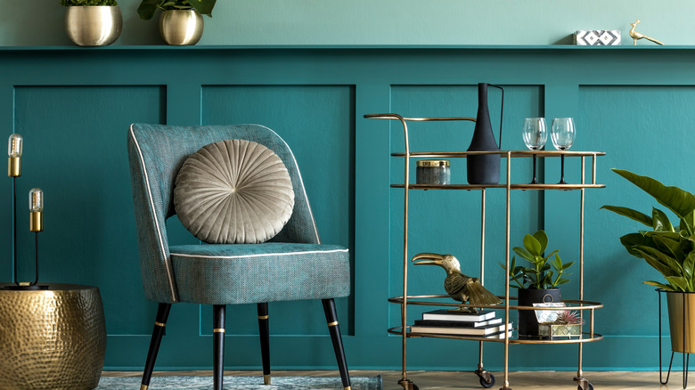 teal paneling and chair