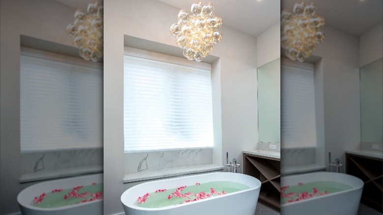 unique light fixture over bathtub