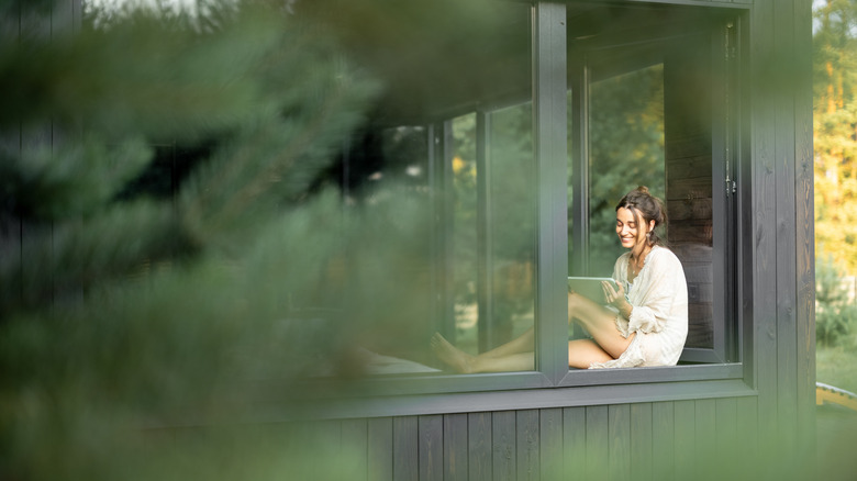 woman sitting in window