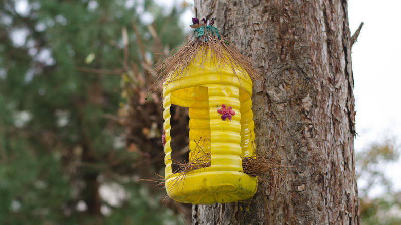 yellow plastic bottle birdhouse