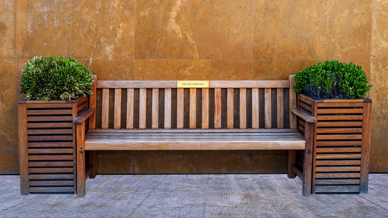 wooden bench flanked by planter boxes