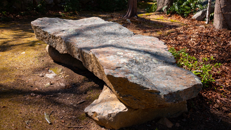 stone garden bench with lichens