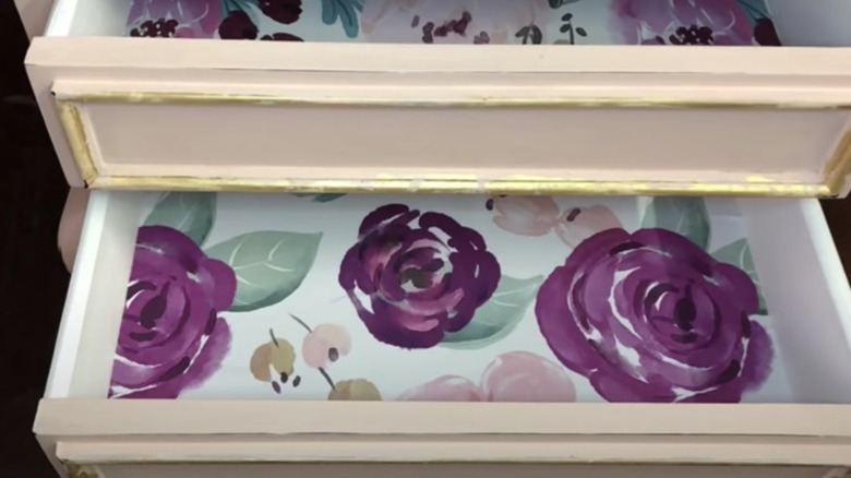 floral wallpaper inside pink drawers