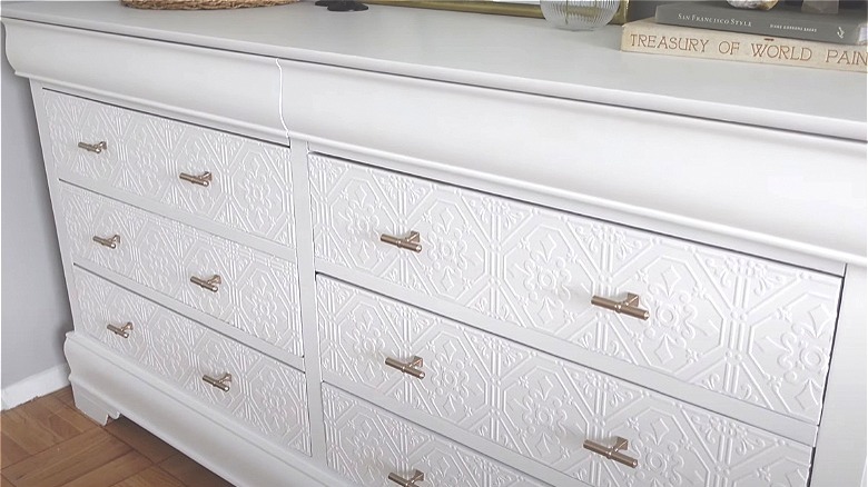 white wallpaper on dresser drawers