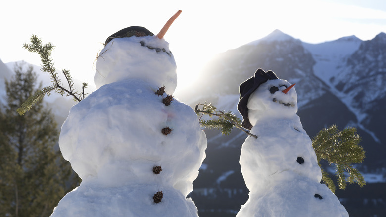 snowmen with pine cone and charcoal buttons