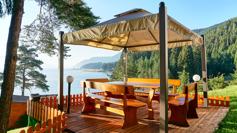 pavilion covering wooden furniture on a small patio