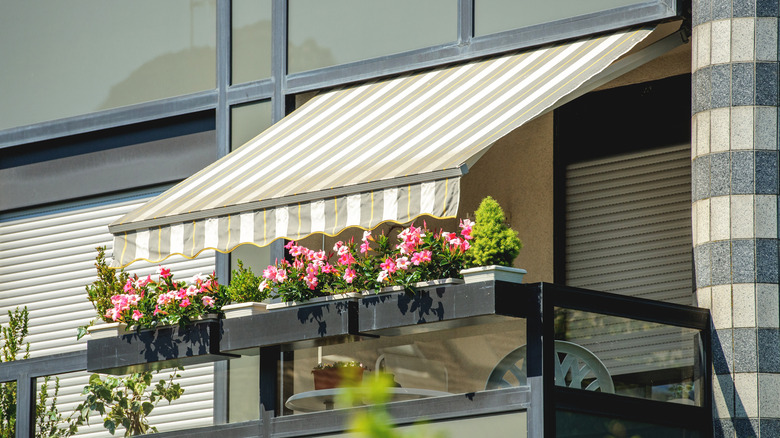 retractable awning on balcony with flowers