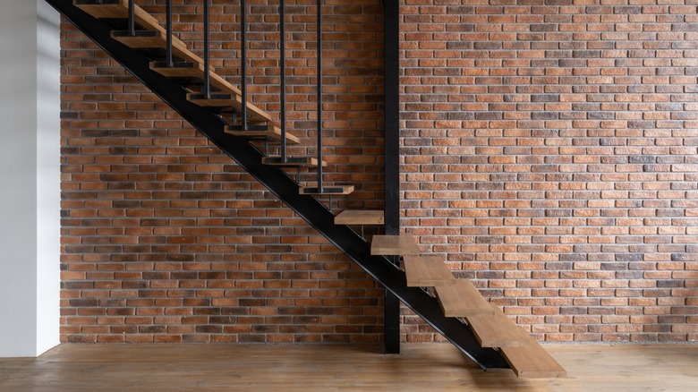 brick wall adjacent to staircase