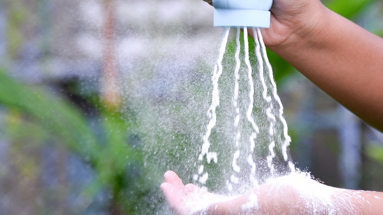 Pouring baby powder into hand